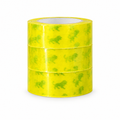 Bundle of yellow tape rolls with green printed markings on a clean white background